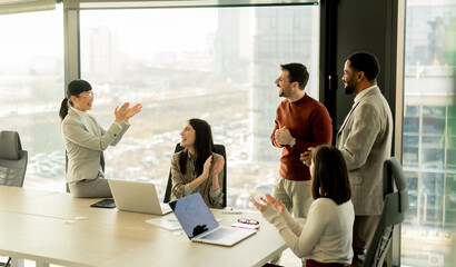 Collaboration among diverse professionals in modern office space during a strategic meeting