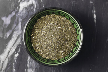 Dried peppermint tea. Crushed green herbs. Organic natural mint. Flatlay marble background. Vegan...