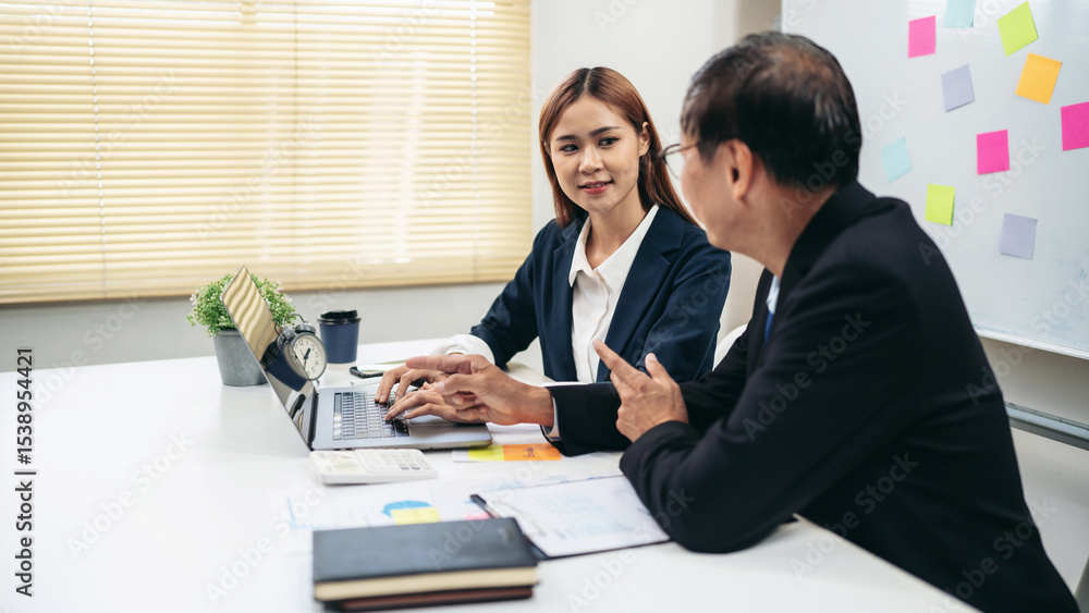 Poster a man and a woman are sitting at a table with a laptop in front of them