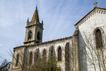 Fototapeta premium Neo-Gothic Church of Santiago in Mondoñedo, Lugo, Galicia, Spain. Historic architecture under clear skies in a quiet town square.