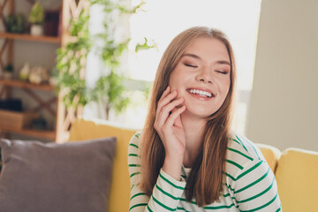 Fototapeta premium Charming Young Woman Smiling Joyfully in a Bright Home Interior with Daylight
