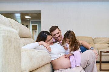 Happy family expecting second child at home