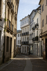 Narrow white street in Mondoñedo, Lugo, Galicia, Spain, with traditional stone houses and charming old-world architecture under soft daylight.
