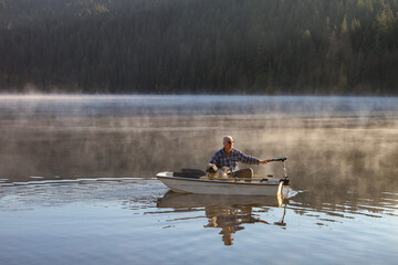 Elderly man and his dog cruising in a small fiberglass fishing boat with an electric motor on Elk...