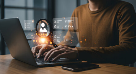 Person using laptop, with glowing digital overlays showing a magnifying glass over a profile icon and check lists, signifying online reputation management and review monitoring for business.
