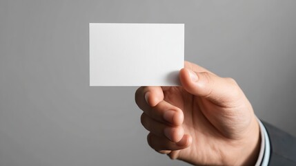 Fototapeta premium Business Card Mockup: Man Holding Blank White Card