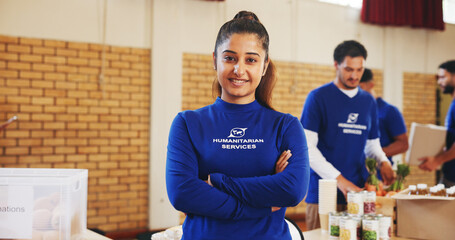 Arms crossed, woman and volunteer for humanitarian NGO, relief aid or help in portrait. Social...