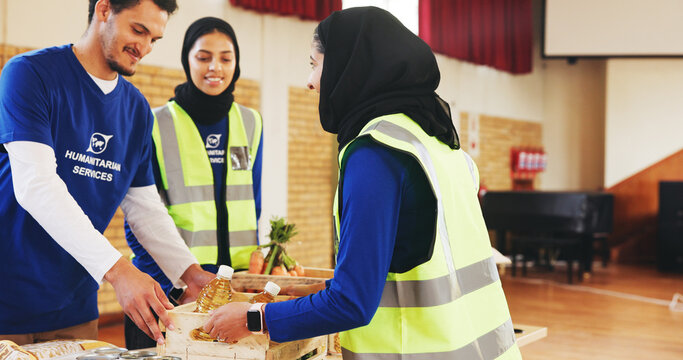 Food drive, volunteer and people with donation for help, non profit or community outreach. Charity, happy group and giving grocery for humanitarian aid, assistance or distribution at ngo with crate