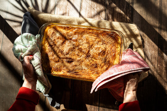 Glass platter with a meat or shepherd's pie on a rustic country table.