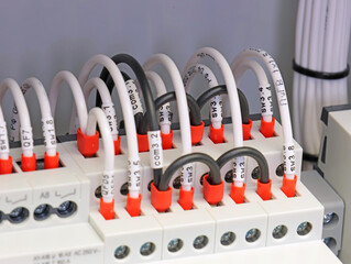 Marking electrical wiring wires with thermally printed nylon tape. 