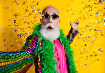 Portrait of eccentric funky aged man make selfie confetti wear shiny costume isolated on yellow...