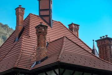Old brick chimneys on historic buildings. Need for repair of damaged historic architecture.