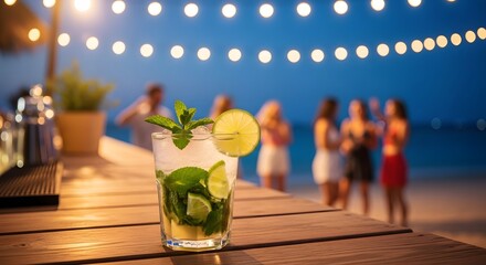 Mojito cocktail with mint and lime served on a wooden bar counter at an outdoor beach party under string lights at night