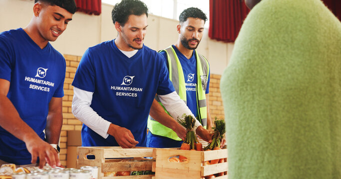 Food bank, volunteer and donation for homeless person, poverty relief or community outreach. Charity, group or giving grocery for humanitarian aid, distribution or help for hunger with carrots at ngo