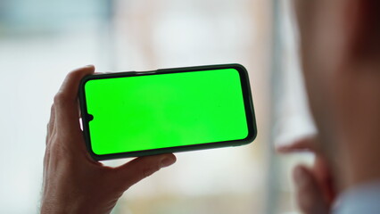 Man hands touching chroma key smartphone in apartment closeup. Freelancer phone
