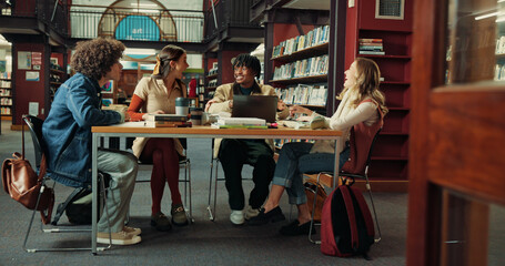Happy, study group and college with friends in library for research project, comedy or education. University, funny and scholarship opportunity with people laughing on campus for academy and course