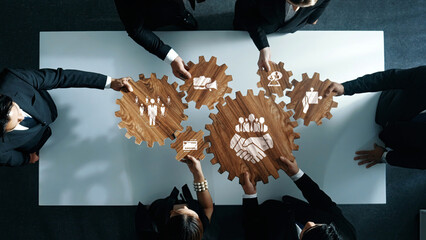 Collaboration and Partnership Concept with Wooden Gears Symbolizing Business Growth and Teamwork in...