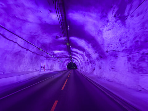 Purple illuminated road inside the laerdal tunnel in norway