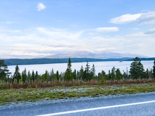 Capturing the essence of norway: a stunning view of a tranquil lake and majestic mountains from a...