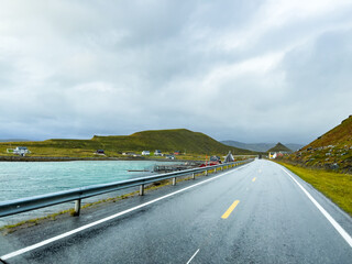 Traveling through stunning norwegian scenery under a dramatic cloudy sky. Nordkapp