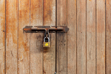 Rusty door latch with padlock