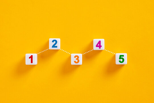 Numbered cubes forming increasing chart on yellow background