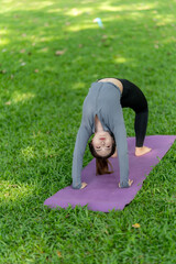 Woman in Wheel Pose on Yoga Mat in Park