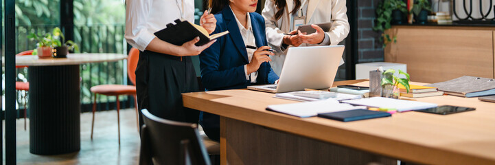 Young office trainee receiving support from mentor and supervisor in structured training environment