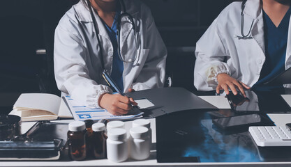 Male and female doctors are having a meeting in a hospital room.