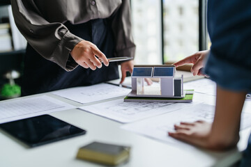 Designer reviewing architectural blueprint for interior project in office