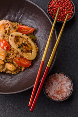 Rice and prawns or paella, a meal with seafood and vegetables. Cooked rice with shrimp