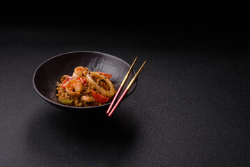 Rice and prawns or paella, a meal with seafood and vegetables. Cooked rice with shrimp