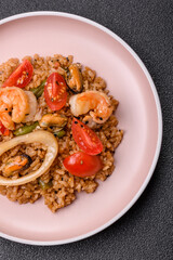 Rice and prawns or paella, a meal with seafood and vegetables. Cooked rice with shrimp