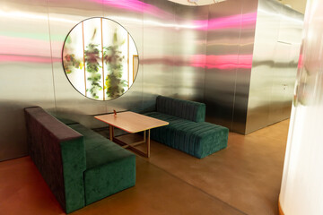 Interior of a nice modern cafe with cozy chairs and mirror on the wall