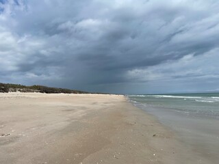 beach sand clouds with rain on the way
