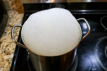 A Burnt Pot On A Kitchen Stove With Dish Detergent Inside To repair Cooking Pan