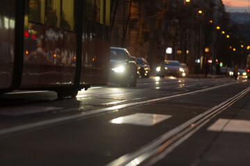 The evening scene depicts an urban traffic layout, showcasing bustling trams and numerous cars...