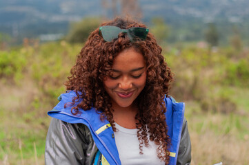Young biologist smiling and studying notes outdoors in nature reserve