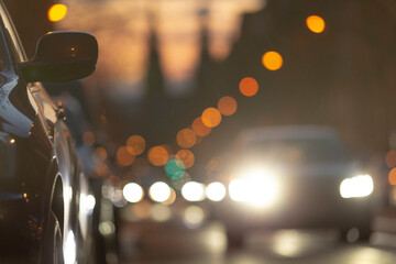 As dusk settles over the city, evening traffic lights up with bright headlights and taillights,...