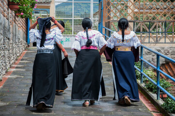 Indigenous women walking in traditional clothes in otavalo, ecuador