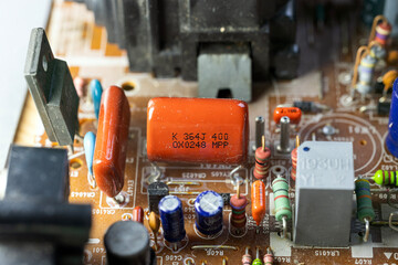 Close-up of an old circuit board with various electronic components. Includes capacitors,...