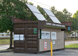 Neighborhood clothing donation station with solar panels charity dropoff bin.