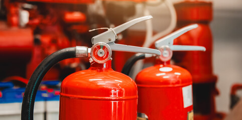 Engineer checks fire extinguisher in fire control room to ensure safety. When an emergency occurs