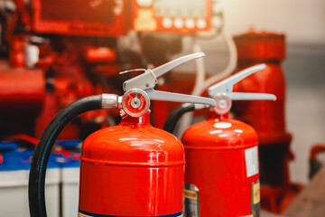 Engineer checks fire extinguisher in fire control room to ensure safety. When an emergency occurs