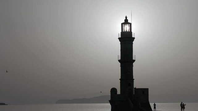 Chania town by night, Lighthouse, Drone shot, Crete, Greece, Aerial view of Chania with the amazing lighthouse, Beautiful Old city, Greece and best scenic places - panorama of picturesque old town 