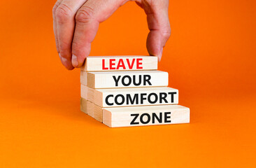 Leave your comfort zone symbol. Concept words Leave your comfort zone on beautiful wooden blocks. Beautiful orange paper background. Business psychological Leave your comfort zone concept. Copy space.