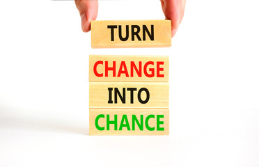 Turn change into chance symbol. Concept words phrase Turn change into chance on beautiful wooden blocks. Beautiful white paper background. Business Turn change into chance concept. Copy space.