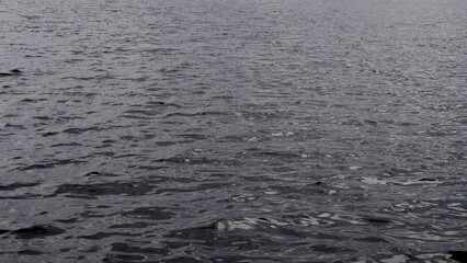 Dark river water, small waves