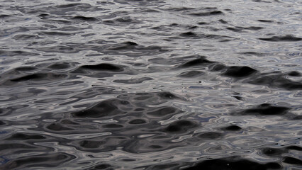 Dark river water, small waves