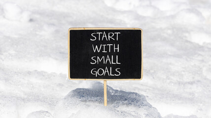 Start with small goals symbol. Concept words phrase Start with small goals on beautiful black...